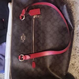 Dark brown and red coach logo purse